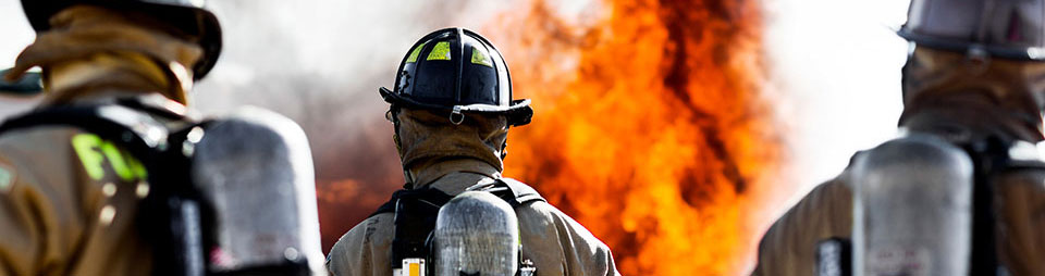 eBook: Designing Public Safety Networks Three firemen fighting a fire